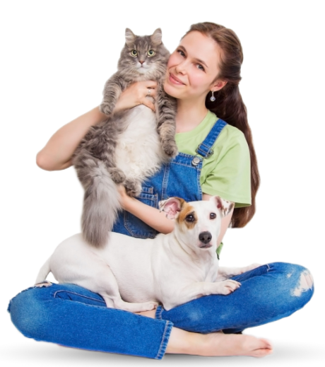 Woman sitting on the floor holding a cat with a dog beside her