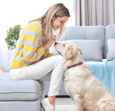 a girl happily posing with a dog